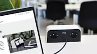 a laptop computer sitting on top of a white desk